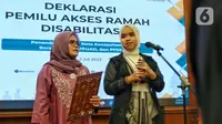 Pelaksana Harian (Plh.) Ketua Bawaslu RI Lolly Suhenty (kiri) bersama Penyanyi difabel Putri Ariani saat mendeklarasikan Pemilu Ramah Disabilitas, di Jakarta, Kamis (6/7/2023). (Liputan6.com/Angga Yuniar)