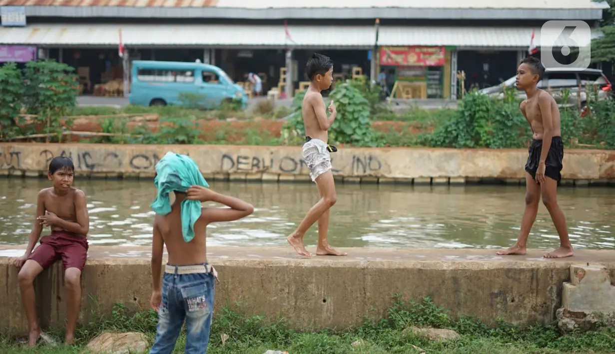 Anak-anak berenang di aliran Sungai Kalimalang, Jakarta, Selasa (18/8/2020). Keterbatasan ekonomi menyebabkan anak-anak tersebut memanfaatkan Sungai Kalimalang sebagai tempat berenang, meskipun berbahaya bagi keselamatan dan kesehatan mereka. (Liputan6.com/Immanuel Antonius)