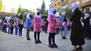Siswa mengenakan masker pada hari pertama mereka kembali ke sekolah di Damaskus, Suriah, Minggu (13/9/2020). Lebih dari tiga juta siswa bersekolah di daerah yang dikuasai pemerintah, menandai hari sekolah pertama di tengah langkah ketat untuk mencegah penyebaran COVID-19. (SANA via AP)