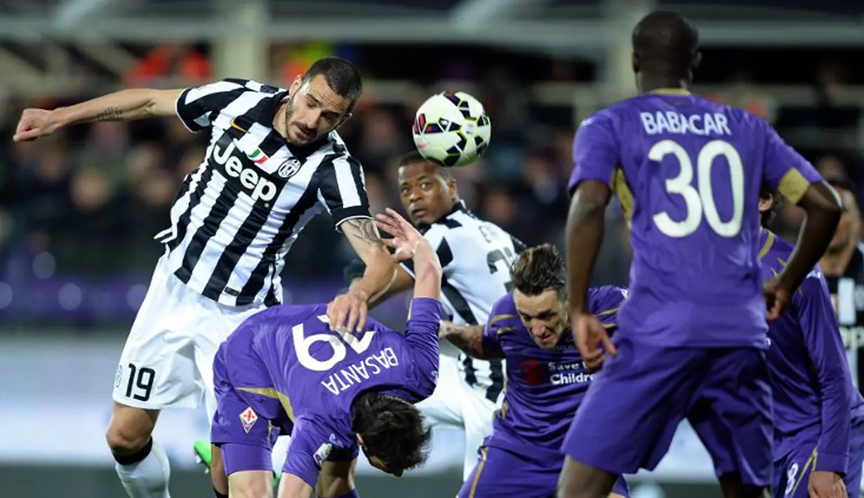 Bek Juventus, Leonardo Bonnuci (kiri) berebut bola dengan pemain Fiorentina pada leg kedua Semifinal Coppa Italia di stadion Artemio Franchi,Italia, Rabu (8/4/2015). Juventus menang 3-0 atas Fiorentina. (AFP PHOTO/Filippo Monteforte)