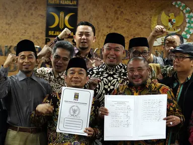 Ketua Fraksi PKS Jazuli Juwaini (kedua kiri) bersama anggota Fraksi PKS DPR menunjukan surat usulan Pansus Jiwasraya di Kompleks Parlemen, Senayan, Rabu (15/1/2020). PKS menandatangani usulan dukungan pembentukan panitia khusus (pansus) untuk membongkar kasus Jiwasraya. (Liputan6.com/Johan Tallo)