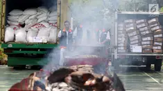 Petugas dari Kementerian Perdagangan memusnakan gula kristal dan daging beku yang sudah kedaluwarsa hasil sitaan dari pasar dengan cara di bakar, di Lapangan Parkir Kemendag, Jakarta Kamis (28/9). (Liputan6.com/JohanTallo)