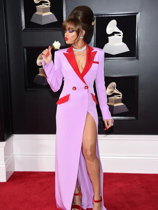 Andra Day berpose sambil memegang bunga saat menghadiri Grammy Awards ke-60 di Madison Square Garden, New York (28/1). (Photo by Evan Agostini/Invision/AP)