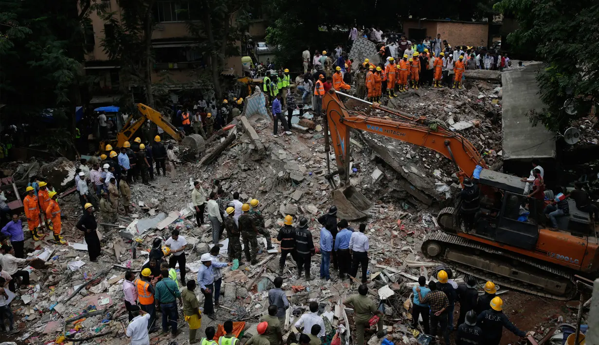 Suasana lokasi runtuhnya gedung berlantai lima di Mumbai, India, Selasa (25/7). Sejauh ini terdapat 4 orang tewas dan puluhan lainnya luka-luka yang telah berhasil dievakuasi oleh petugas. (AP/Rafiq Maqbool)