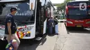 Calon penumpang bersiap menaiki bus di Terminal Kampung Rambutan Jakarta, Kamis (24/3/2022). Pemerintah memastikan bahwa masyarakat diperbolehkan mudik Lebaran tahun 2022 dengan syarat sudah mendapatkan vaksin dosis lengkap dan ketiga atau booster. (Liputan6.com/Herman Zakharia)