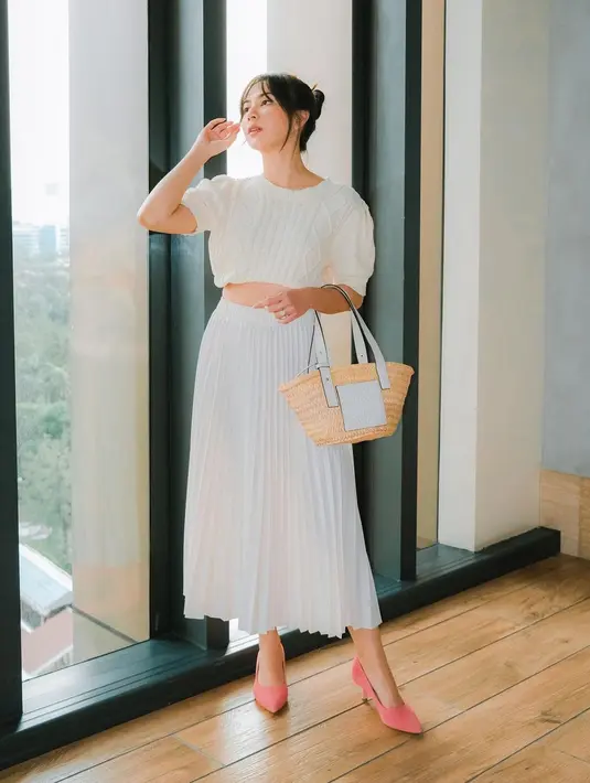 Tampil dengan outfit serba putih, gaya simpel namun cantik ala Jessica Mila ini bisa jadi inspirasi. Atasan beraksen pleats serasi dengan rok panjang, dan tas yang ditentengnya. Foto: Instagram.