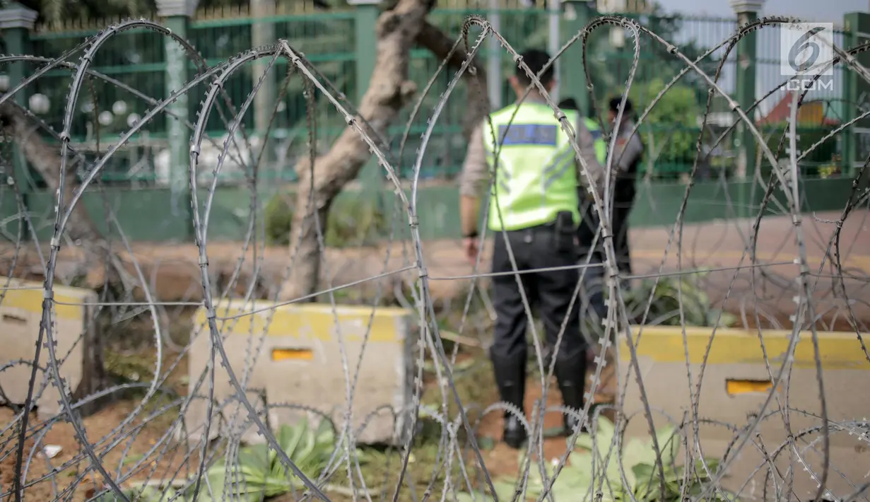 Pihak kepolisian memasang kawat berduri jelang unjuk rasa yang akan digelar mahasiswa di depan gedung DPR/MPR, Selasa (24/9/2019). Polisi juga memasang pembatas beton di belakang kawat duri itu serta menyiagakan beberapa unit Barracuda milik Brimob di sekitar DPR. (Liputan6.com/Faizal Fanani)
