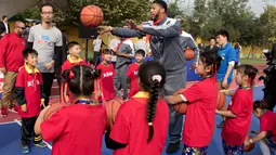 Para siswa berlatih dengan pemain New Orleans Pelicans Anthony Davis di Sekolah Migran Huangzhuang, Beijing, Tiongkok (11/10). Kedatangan bintang NBA ini untuk ajang pemanasan sebelum dimulainya musim reguler NBA 2016/2017. (AP Photo/Ng Han Guan)