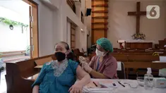 Petugas kesehatan menyuntikkan vaksin COVID-19 penguat (booster) atau dosis ketiga di Gereja Huria Kristen Batak Protestan Menteng Anno 1955, Jakarta Pusat, Selasa (25/1/2022). Layanan vaksinasi dosis ketiga di gereja tersebut menyediakan kuota 500 vaksin per hari. (Liputan6.com/Herman Zakharia)