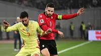 Ferran Torres (Timnas Spanyol), kiri, berebut bola dengan Khvicha Kvaratskhelia (Timnas Georgia) pada laga Kualifikasi Piala Dunia 2026 Grup E antara Georgia dan Spanyol di Tbilisi, Georgia, Sabtu, 15 November 2025. (AP Photo/Tamuna Kulumbegashvili)