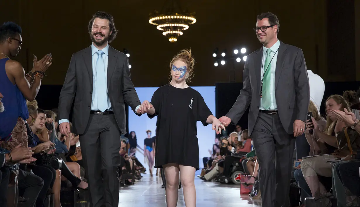 Desainer Hendrik Vermeulen (kiri) dan Madeline Stuart, model Australia dengan down syndrome berjalan di atas catwalk usai peragaan busana untuk Musim Panas dan Semi 2016 di New York Fashion Week, Minggu (13/9/2015). (REUTERS/Andrew Kelly)