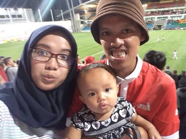 Seorang The Jakmania bernama Mustopha mengajak istri dan sang putri yang masih berusia delapan bulan untuk away days saat Persija Jakarta tandang ke Singapura pada laga AFC Cup. (Bola.com/Istimewa)