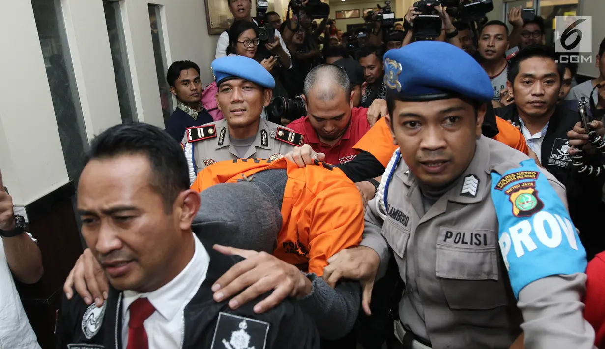Polisi mengawal tersangka DM dan DMT saat di bawa pada rilis penangkapan narkoba di Polres Jakarta Selatan, Jumat (11/8). Dari hasil penangkapan ditemukan dua paket ganja dengan berat dibawah 5 gram.  (Liputan6.com/Herman Zakharia)