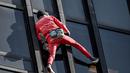 Alain Robert, pendaki bangunan pencakar langit asal Prancis memanjat Menara Montparnasse di Paris, Prancis, Rabu (12/10/2022). Alain Robert yang dikenal sebagai Spiderman Prancis itu kembali beraksi dengan memanjat Menara Montparnasse yang memiliki ketinggian 210 meter. (Bertrand GUAY/AFP)
