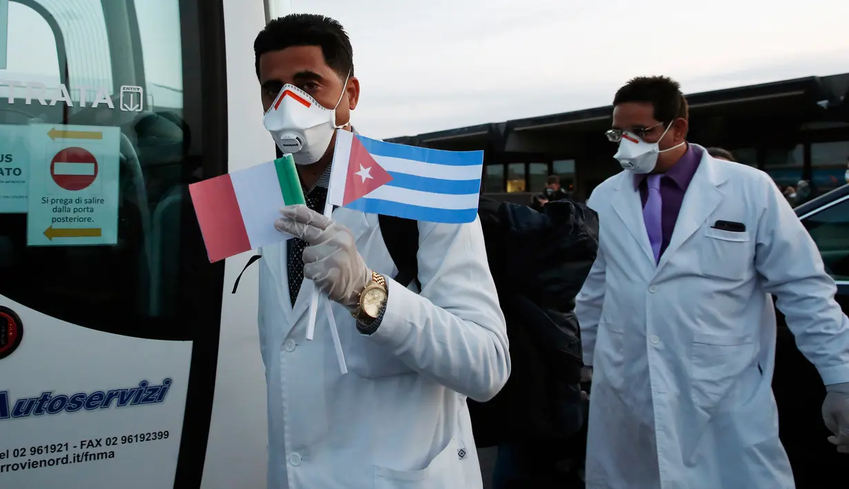 Tenaga medis dan paramedis dari Kuba tiba di bandara Malpensa di Milan, Italia, Minggu (22/3/2020). Kedatangan 53 orang dokter dan perawat dari Kuba bertujuan membantu mengendalikan pandemi virus corona di kawasan Lombardia yang merupakan wilayah terdampak paling parah. (AP/Antonio Calanni)