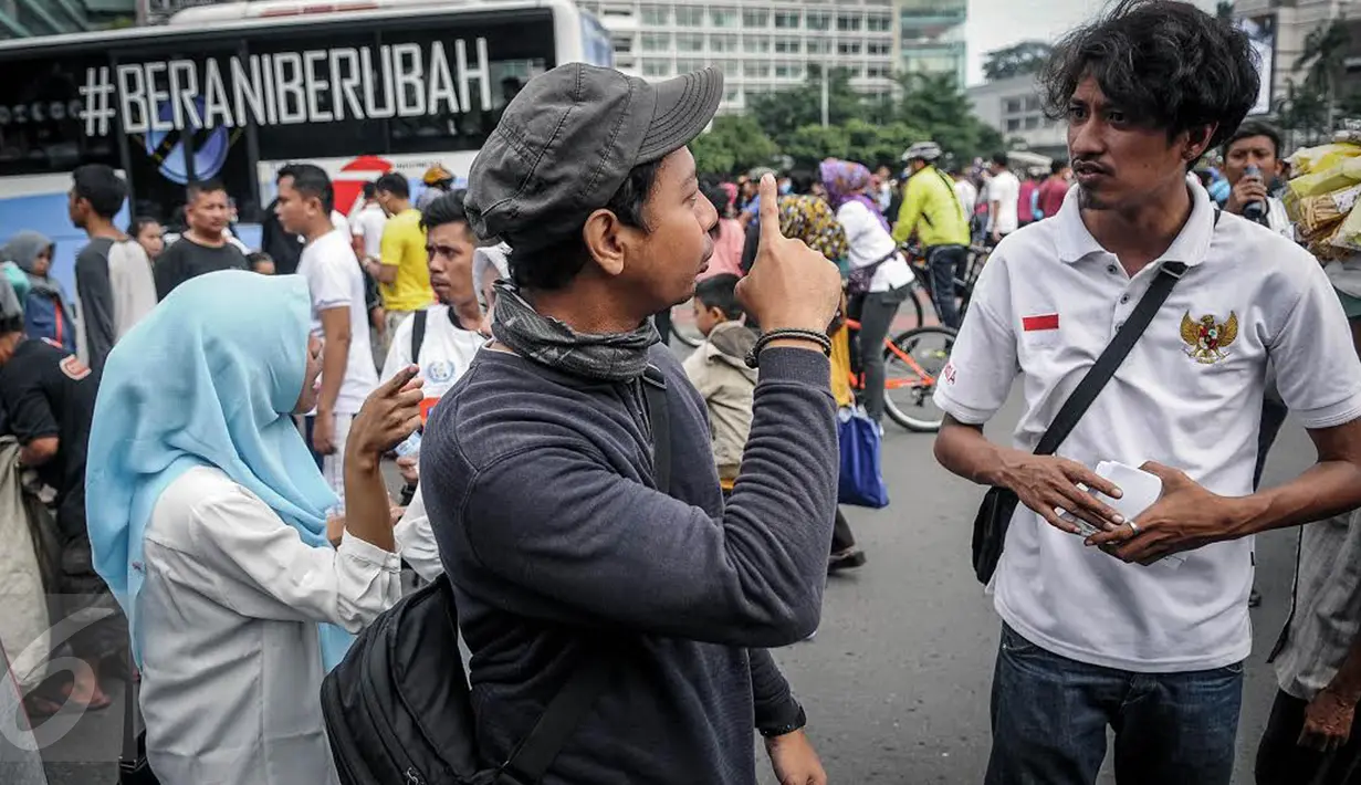 Penyandang disabilitas tuna rungu dan tuna wicara berkumpul memperingati Hari Tuli Internasional di arena Car Free Day, Jakarta, Minggu (25/9). Dalam kampanye ini, mereka memperagakan bahasa isyarat kepada warga masyarakat. (Liputan6.com/Faizal Fanani)
