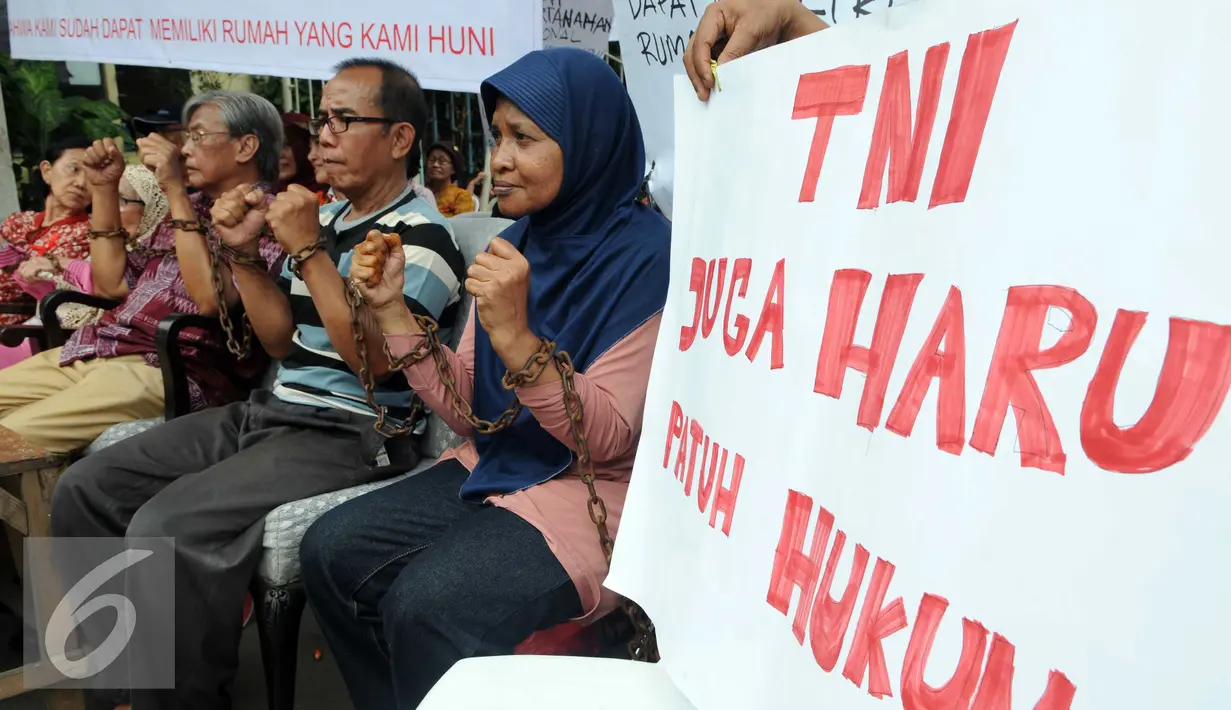Sejumlah warga para sesepuh veteran merantai tangannya saat mengelar aksi di kawasan sungai bambu, Jakarta Utara, Rabu (3/2). Dalam aksi mereka menolak pengosongan rumah negara secara paksa terhadap 6 rumah negara. (Liputan6.com/Helmi Afandi)