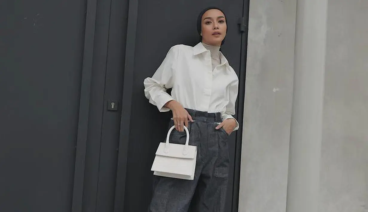 Bisa jadi ide styling yang kece, padukan kemeja putih dengan turtleneck top dan boyfriend jeans. Heels putih pun memberikan kesan elegan pada keseluruhan tampilanmu. (Instagram/viratandia).