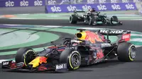 Pembalap Red Bull Max Verstappen beraksi di depan pembalap Mercedes Lewis Hamilton pada F1 GP Arab Saudi di Jeddah, Minggu, 5 Desember 2021. Kemenangan Lewis Hamilton membuatnya kini menyamai poin Max Verstappen di klasemen F1, yakni 369,5 poin. (AP Photo/Amr Nabil)