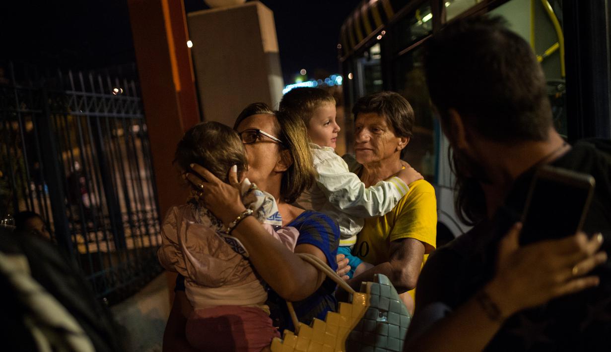 Sejumlah penumpang kapal feri Eleftherios Venizelos dievakuasi petugas saat kapal terbakar di pelabuhan Piraeus, dekat Athena, (29/8). Kapal feri tersebut mengangkut 875 penumpang dan 141 awak. (AFP Photo/Angelos Tzortzinis)