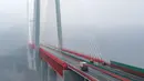 Kendaraan melintasi jembatan Beipanjiang di dekat Bijie, Provinsi Guizhou, barat daya China, 28 Desember 2016. Jembatanyang setara dengan ketinggian gedung 200 lantai itu itu menghubungkan provinsi Yunan dan Guizhou. (STR / AFP)