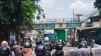 Truk kontainer tersangkut talang air di Jalan KS Tubun, Kota Bogor dan peti kemas yang diangkut menimpa mobil di belakangnya. Kecelakaan ini juga menyebabkan kemacetan parah di sekitar jalan KS Tubun, Bogor. (Liputan6.com/Achmad Sudarno)