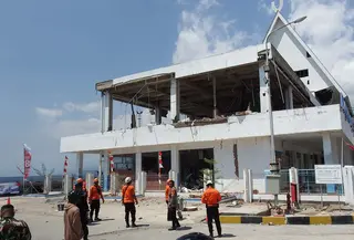 Tim penyelamat mencari korban di reruntuhan setelah gempa berkekuatan magnitudo 7,7 mengguncang Pulau Flores di  Pelabuhan Laurensius Say di Maumere, Sikka, Nusa Tenggara Timur, Sabtu, 15 Agustus 2026. (AFP/ Arnold Welianto)