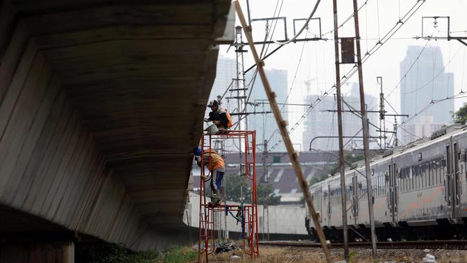Pekerja melakukan proses pembangunan kontruksi jalur rel dwi ganda di Jakarta, Jumat (13/4). Penyelesaian proyek infrastruktur jalur DDT Manggarai- Cikarang ini ditargetkan lebih cepat dari target awal tahun 2022. (Liputan6.com/Johan Tallo)