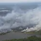 Kebakaran lahan di Riau dengan kepulan asap sehingga menimbulkan polusi udara. (Liputan6.com/M Syukur)