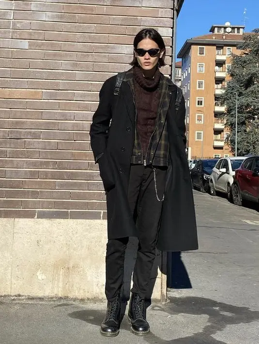 Mahasiswa Ilmu Komunikasi di salah satu perguruan tinggi negeri di Surabaya ini tampil fashionable dengan pakaian musim dinginya. Mengenakan layering turtleneck cokelat sebagai inner, jaket geometris, dan long coat hitam untuk luaran. Dipadukan dengan pants dan boots hitam. 