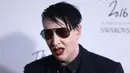 Pose Marilyn Manson saat menghidiri di Fashion Awards 2016 di London, Inggris (5/12). Mengenakan Jas dan kacamata hitam Marilyn Manson tampil keren saat menghadiri acara tersebut. (REUTERS/Neil Balai)