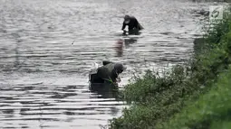 Aktivitas para pencari cacing super di Kanal Banjir Timur, Jakarta, Kamis (14/2). Cacing super ini dijual dengan harga Rp 20 ribu per kilogram. (Merdeka.com/Iqbal Nugroho)