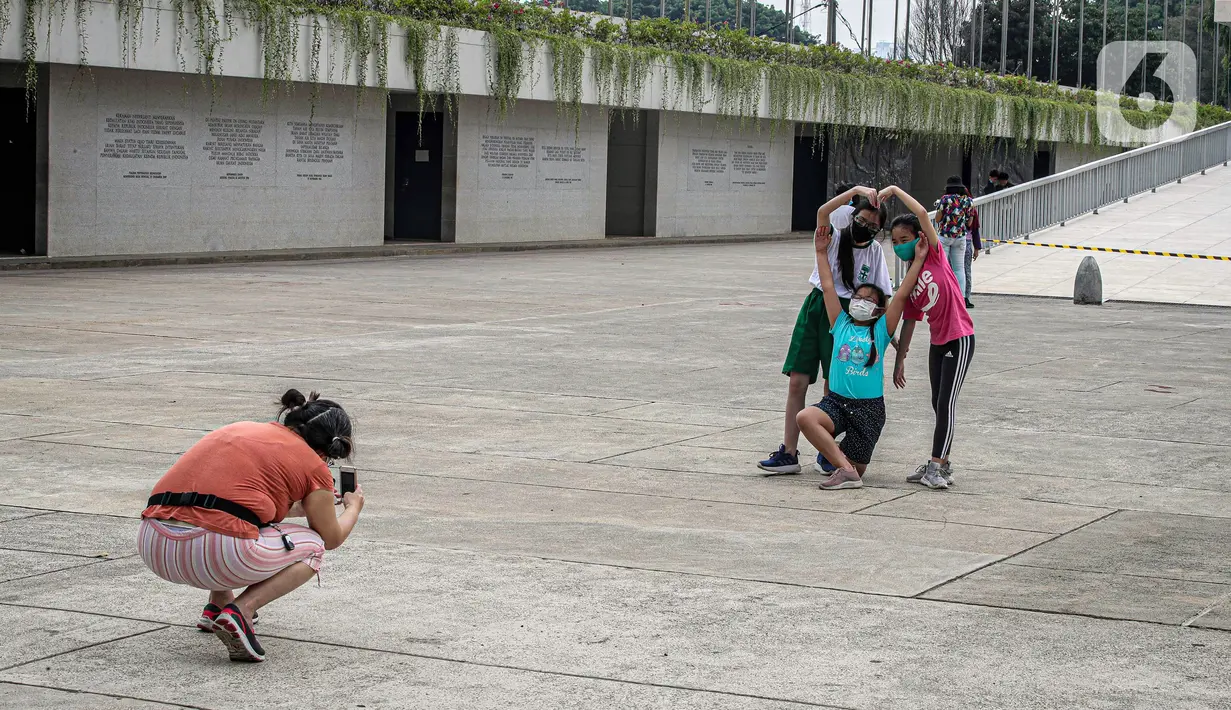 Warga berfoto bersama di Taman Lapangan Banteng, Jakarta, Minggu (18/10/2020). Taman Lapangan Banteng kembali dibuka di masa PSBB Transisi dengan protokol kesehatan ketat. (Liputan6.com/Faizal Fanani)