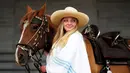 Seorang wanita menuntun kuda untuk mengikuti festival  Calgary Stampede di Calgary , Alberta , Kanada, (9/7). Acara ini telah ada sejak abad ke-19 dan telah menarik banyak pengunjung.( REUTERS / Todd korol)