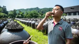 Dong Bin, kepala pabrik pembuatan cuka, mencicipi cuka untuk memeriksa kualitasnya di Chishui, Provinsi Guizhou, China barat daya (26/6/2020). Chishui terkenal dengan cuka mataharinya, yang masih mempertahankan proses pembuatan secara tradisional. (Xinhua/Tao Liang)