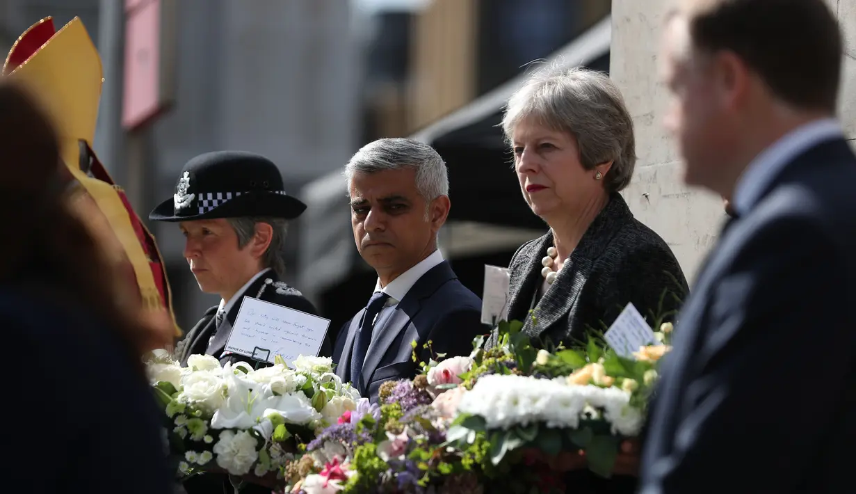 PM Inggris Theresa May didampingi Walikota London Sadiq Khan menghadiri upacara peringatan setahun serangan teror Jembatan London, di London Bridge, Inggris (3/6). (AFP/Daniel Leal-Olivas)