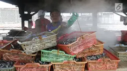 Warga memasak ikan asin secara tradisional di Muara Angke, Jakarta, Rabu (13/9). Produksi ikan asin yang merupakan usaha rumah tangga nelayan di daerah tersebut mengalami peningkatan hingga 50 persen saat musim kemarau. (Liputan6.com/Angga Yuniar)