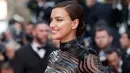 Model Irina Shayk berpose ketika menghadiri pemutaran perdana film 'The Beguiled' di karpet merah Festival Film Cannes 2017, Rabu (24/5). Gaun rancangan Olivier Rousteing itu dipadukan dengan oversized belt berbentuk korset. (AP Photo/Alastair Grant)