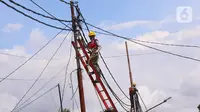 Petugas melakukan pemeliharaan kabel listrik di Jakarta, Sabtu (26/12/2020). PT PLN (Persero) menjamin ketersediaan pasokan listrik sepanjang Natal dan Tahun Baru 2020-2021. (Liputan6.com/Angga Yuniar)