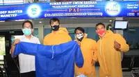 Perwakilan RSUD Kanjuruhan menerima bantuan APD dari pesepak bola Malang Raya yang diwakili Jayus Hariono, Edy Gunawan, dan Yanuar Tri Firmanda, Rabu (20/5/2020). (Bola.com/Iwan Setiawan)