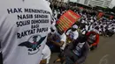 Dalam aksinya, massa mengenakan kaos yang menyuarakan aspirasi mereka, Jakarta, Senin (1/12/2014). (Liputan6.com/Faizal Fanani) 