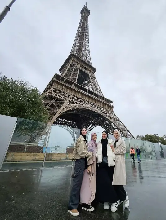 Berada di menara eiffel, Dian Ayu mengenakan jaket dengan aksen plisket dan celana hitamnya. Natasha dengan gamis pink dan kerudung motif, Ratna Galih dengan padding jaket putih dan inner serta rok hitam. Nina tampil dibalut coat panjang serta celana hitamnya. [@dianayulestari]