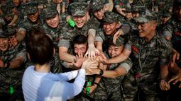 Sejumlah tentara saat berebutan bersalaman dengan penyanyi Kpop yang menghibur mereka di pangkalan laut dekat zona demiliterisasi yang memisahkan Korea Selatan dan Korea Utara, Gimpo, Korea Selatan, 10 Juni 2016. (REUTERS / Kim Hong - Ji)
