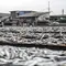 Pekerja menjemur ikan saat proses pengasinan di kawasan Muara Angke, Jakarta, Senin (26/12/2022). Nelayan mengaku produksi ikan asin di muara angke mengalami penurunan, disebabkan terhambatnya proses pengeringan di musim hujan. (Liputan6.com/Faizal Fanani)