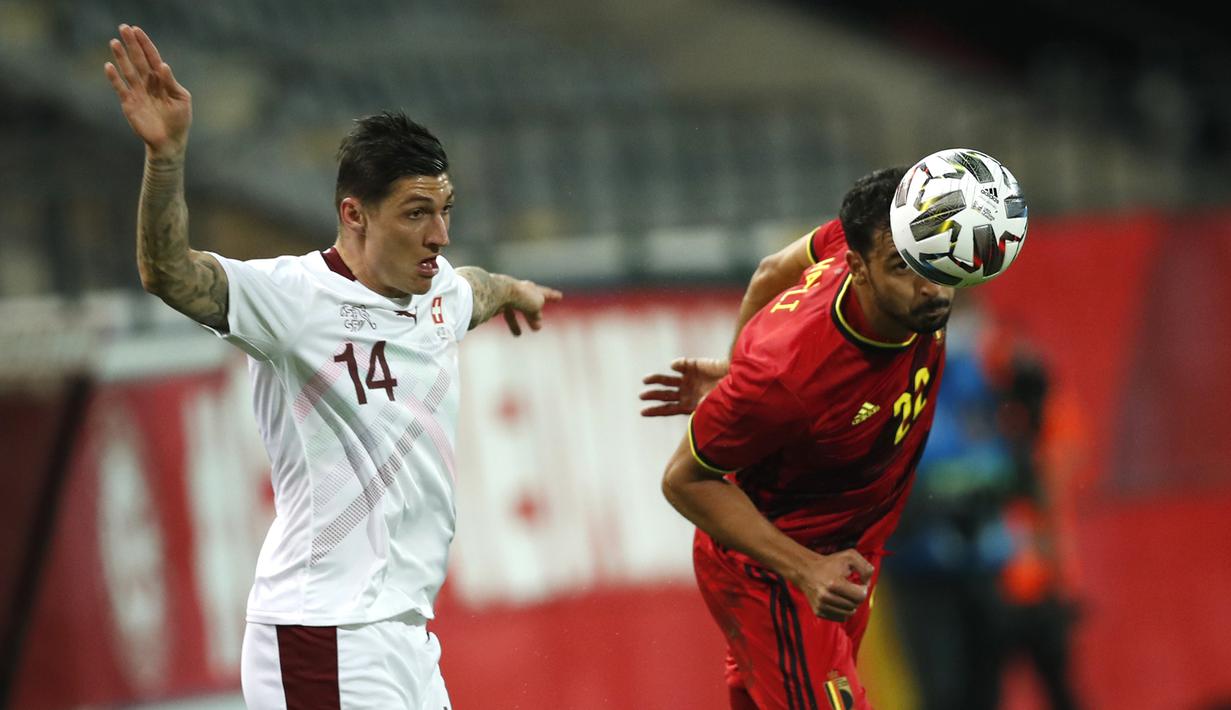Pemain Belgia, Nacer Chadli (kanan), berebut bola dengan pemain Swiss, Steven Zuber, dalam pertandingan uji coba Internasional di Stadion King Power, Belgia, Kamis (12/11/2020) dini hari WIB. Belgia mengalahkan Swiss 2-1. (AP Photo/Francisco Seco).
