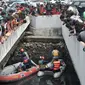 Warga dan pengendara berkerumun melihat upaya tim gabungan melakukan pencarian buaya di Kali Grogol, Jakarta Barat, Kamis (28/6). Pencarian telah dilakukan sejak kemarin siang ketika warga melaporkan penampakan buaya itu. (Merdeka.com/Iqbal S. Nugroho)