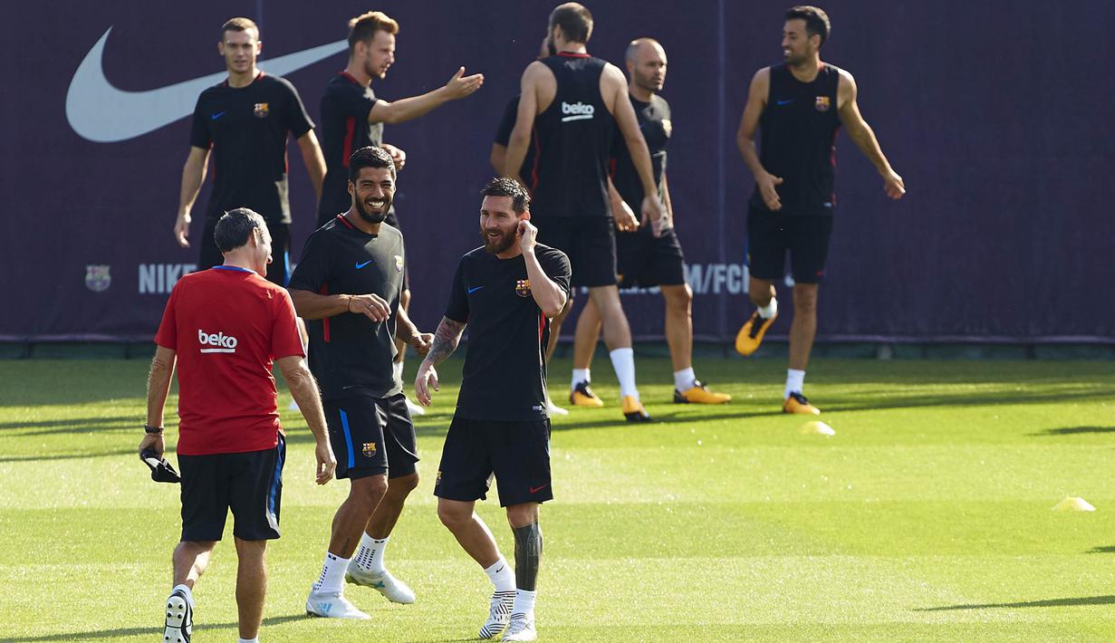 Pemain Barcelona, Suarez dan Messi, bercanda dengan pelatih Barcelona, Valverde, saat latihan di Joan Gamper, Senin (17/7/2017). La Blaugrana menggelar latihan untuk mempersiapkan skuad yang akan menjalani tur pramusim di AS. (EPA/Alejandro Garcia)
