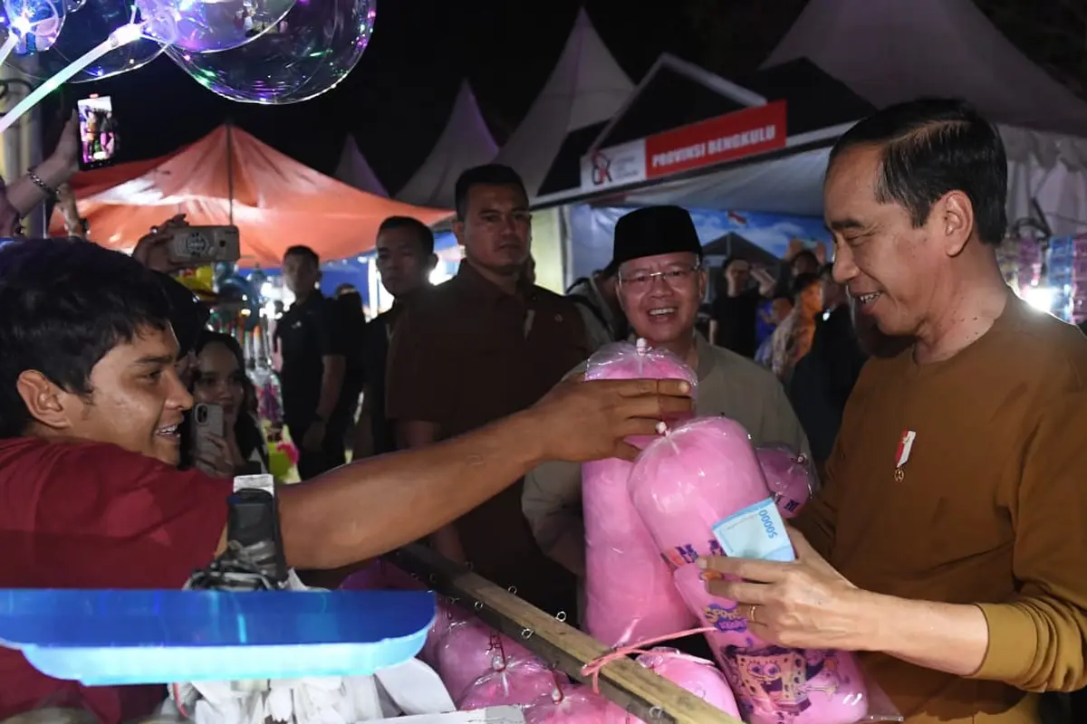 Presiden Joko Widodo jajan gulali saat mengunjungi Festival Tabut 2023 di Lapangan Merdeka Bengkulu Provinsi Bengkulu, Rabu (19/7/2023). (Foto: Kris - Biro Pers Sekretariat Presiden)