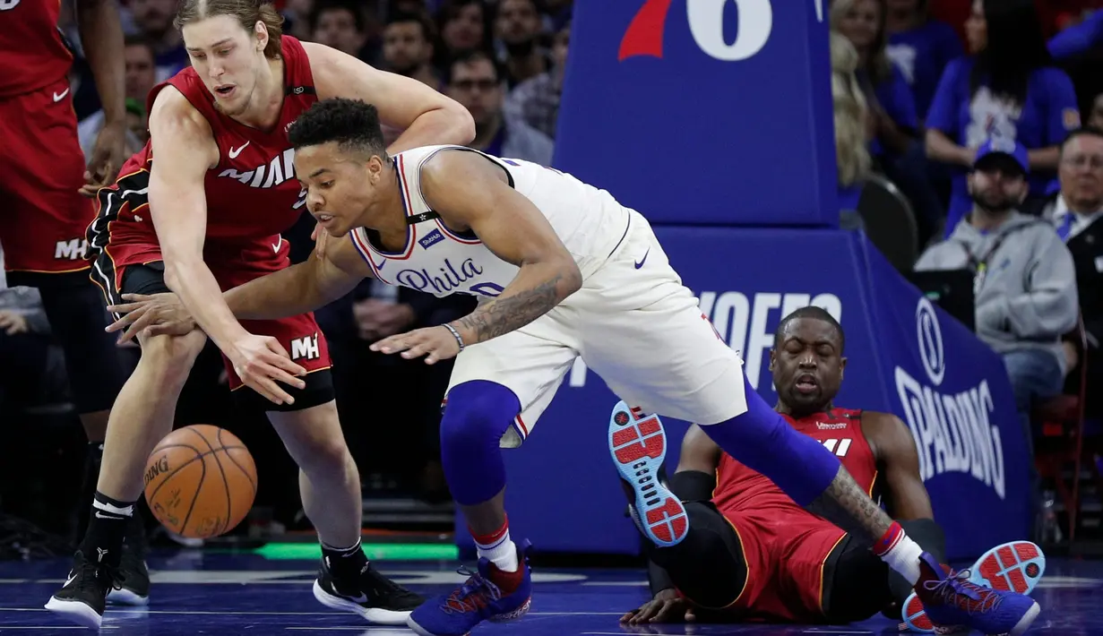 Pemain Philadelphia 76ers, Markelle Fultz (tengah) berebut bola dengan pemain Miami Heat, Kelly Olynyk (kiri) pada NBA basketball playoff series di Wells Fargo Center, Philadelphia, (16/4/2018). Heat menang 113-103. (AP/Chris Szagola)