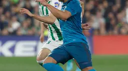 Pemain Real Madrid, Casemiro berebut bola dengan pemain Real Betis, Bartra pada laga pekan ke-24 La Liga Spanyol, di Estadio Benito Villamarin, Minggu (18/2). Real Madrid menang dengan skor 5-3. (AP/Miguel Morenatti)